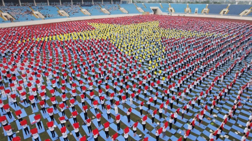 Largest yoga performance to shape national flag sets national record